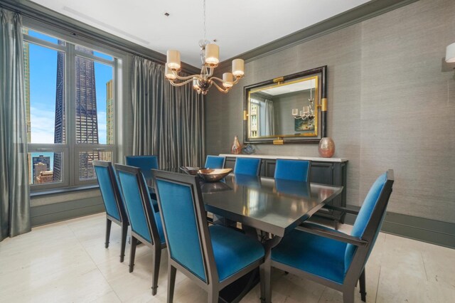dining room featuring a chandelier, healthy amount of natural light, ornamental molding, and wallpapered walls