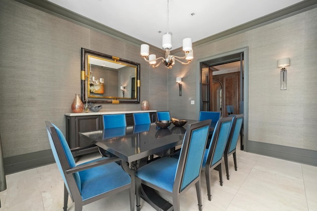dining space with a chandelier, ornamental molding, and baseboards