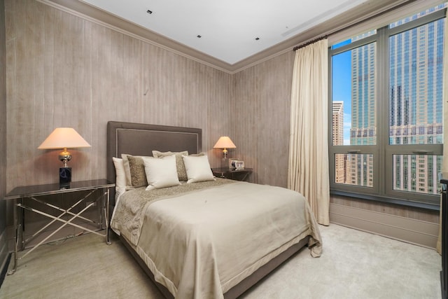 carpeted bedroom featuring ornamental molding and a city view