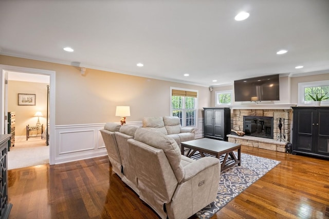 1527 Steeplechase Ct, Green Oaks, IL 60048 - living room with dark wood-style flooring, ornamental molding, healthy amount of natural light, a stone fireplace, and a wainscoted wall