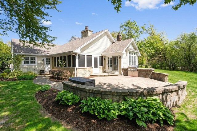 1527 Steeplechase Ct, Green Oaks, IL 60048 - rear view of house featuring an outdoor kitchen, a patio, a lawn, and a sunroom