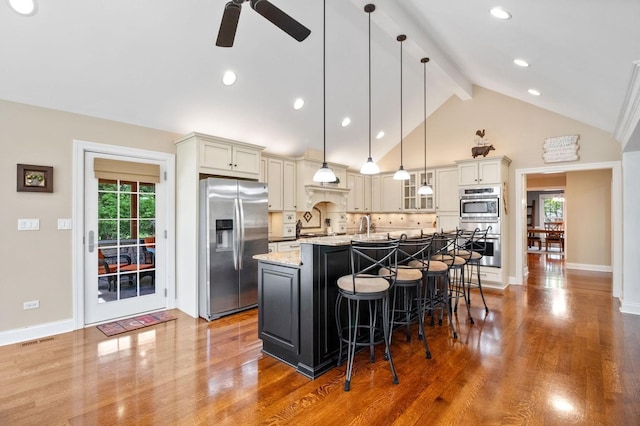 1527 Steeplechase Ct, Green Oaks, IL 60048 - kitchen featuring stainless steel appliances, beam ceiling, a kitchen bar, a ceiling fan, and wood finished floors