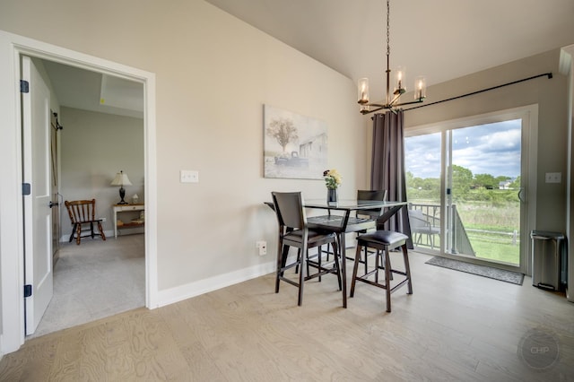 570 Sudbury Cir, Oswego, IL 60543 - dining space with wood finished floors, a chandelier, baseboards, and vaulted ceiling