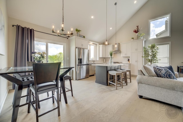 570 Sudbury Cir, Oswego, IL 60543 - dining space with high vaulted ceiling, a chandelier, light wood finished floors, and recessed lighting