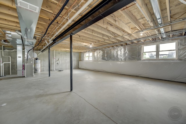 570 Sudbury Cir, Oswego, IL 60543 - below grade area featuring heating unit and water heater