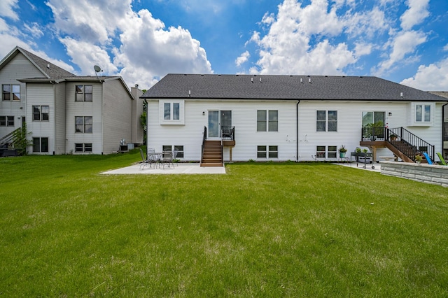 570 Sudbury Cir, Oswego, IL 60543 - rear view of house with stairs, a patio area, a yard, and roof with shingles