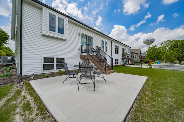 570 Sudbury Cir, Oswego, IL 60543 - rear view of house featuring a patio, central AC unit, and a yard