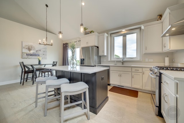 570 Sudbury Cir, Oswego, IL 60543 - kitchen with stainless steel appliances, a kitchen island, a chandelier, white cabinets, and vaulted ceiling