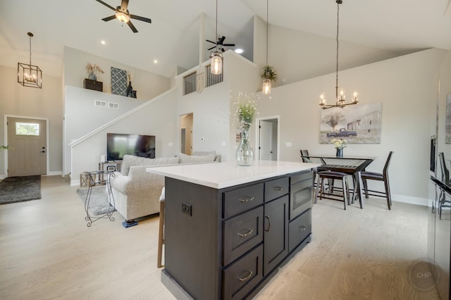 570 Sudbury Cir, Oswego, IL 60543 - kitchen featuring high vaulted ceiling, ceiling fan, a chandelier, stainless steel microwave, and light wood-style floors