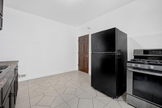 1022 N Lavergne Ave, Chicago, IL 60651 - kitchen featuring freestanding refrigerator, stainless steel range with gas cooktop, and a sink