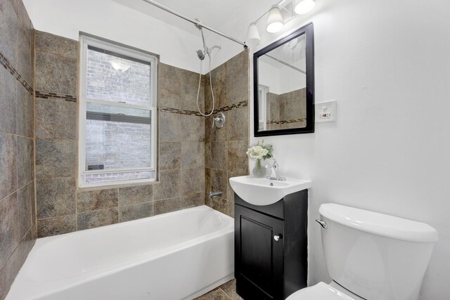 1022 N Lavergne Ave, Chicago, IL 60651 - bathroom featuring healthy amount of natural light, toilet, vanity, and washtub / shower combination