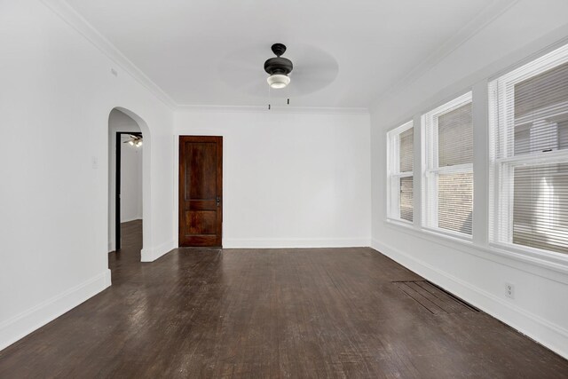 1022 N Lavergne Ave, Chicago, IL 60651 - spare room featuring a ceiling fan, arched walkways, dark wood-style floors, ornamental molding, and baseboards