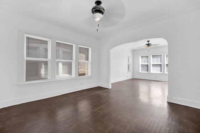 1022 N Lavergne Ave, Chicago, IL 60651 - unfurnished room featuring a ceiling fan, arched walkways, dark wood-style flooring, baseboards, and crown molding
