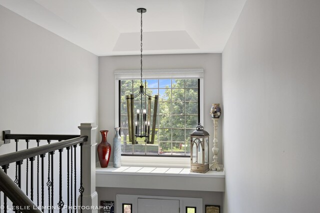 detailed view of a chandelier and a tray ceiling