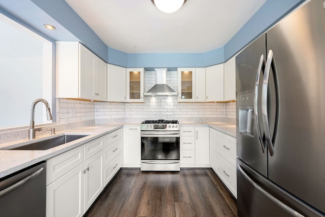 15540 Frances Ln, Orland Park, IL 60462 - kitchen featuring appliances with stainless steel finishes, wall chimney range hood, a sink, light stone counters, and glass insert cabinets