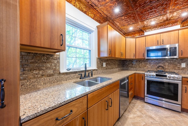 1521 W University Ave, Champaign, IL 61821 - kitchen with appliances with stainless steel finishes, a sink, decorative backsplash, light stone countertops, and an ornate ceiling