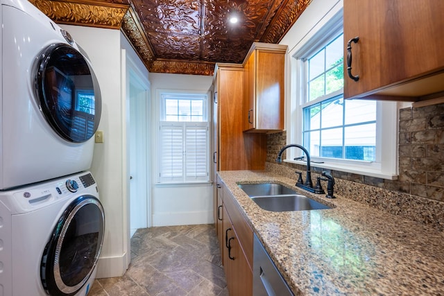 1521 W University Ave, Champaign, IL 61821 - laundry room featuring stacked washing machine and dryer, baseboards, cabinet space, an ornate ceiling, and healthy amount of natural light