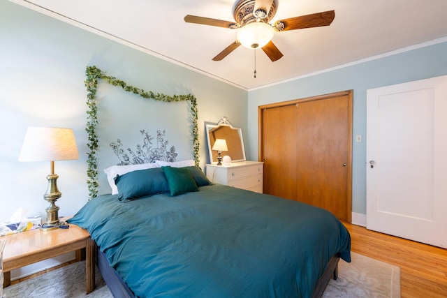 1521 W University Ave, Champaign, IL 61821 - bedroom with a closet, ornamental molding, light wood finished floors, and ceiling fan