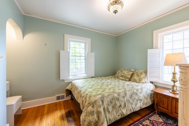 1521 W University Ave, Champaign, IL 61821 - bedroom featuring baseboards, wood finished floors, and crown molding