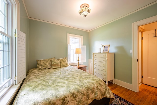 1521 W University Ave, Champaign, IL 61821 - bedroom with crown molding, wood finished floors, and baseboards