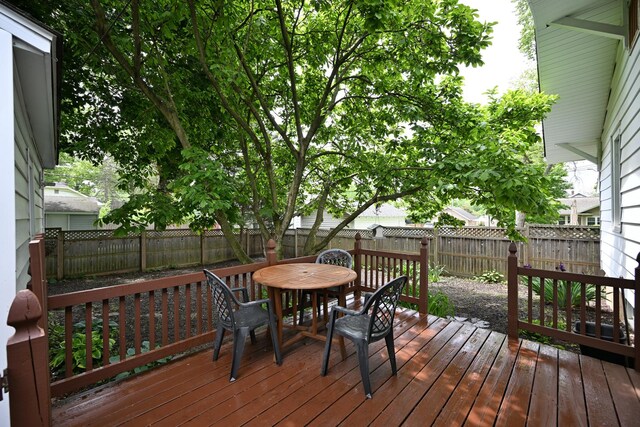 1521 W University Ave, Champaign, IL 61821 - wooden deck with a fenced backyard and outdoor dining space
