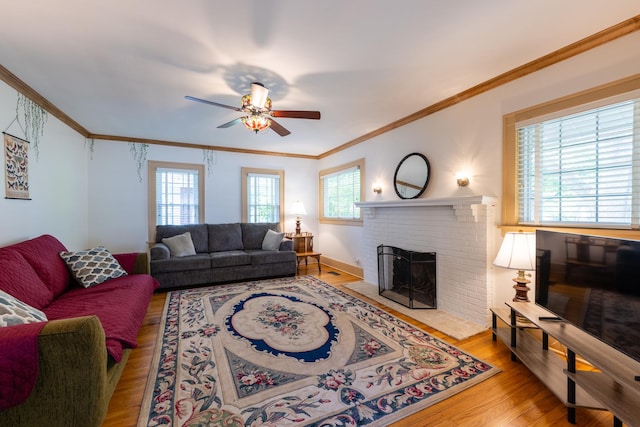 1521 W University Ave, Champaign, IL 61821 - living area featuring wood finished floors, ceiling fan, a brick fireplace, and ornamental molding