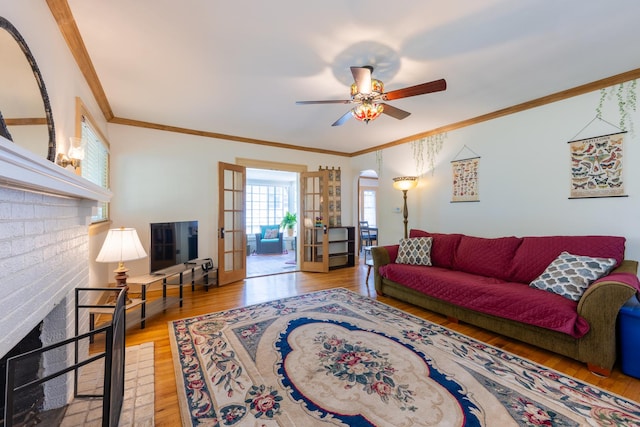 1521 W University Ave, Champaign, IL 61821 - living area with wood finished floors, crown molding, a ceiling fan, and french doors