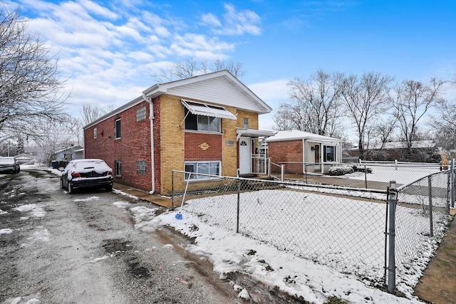 14821 Cooper Ave, Harvey, IL 60426 - view of snow covered exterior with brick siding and a fenced front yard