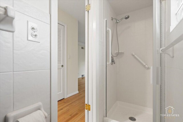 919 Santa Rosa Ave, Wheaton, IL 60187 - full bathroom featuring a shower stall and wood finished floors