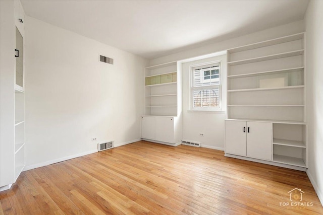 919 Santa Rosa Ave, Wheaton, IL 60187 - empty room featuring light wood-style flooring, baseboards, and built in shelves