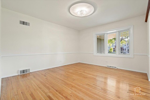 919 Santa Rosa Ave, Wheaton, IL 60187 - spare room featuring wood finished floors and baseboards