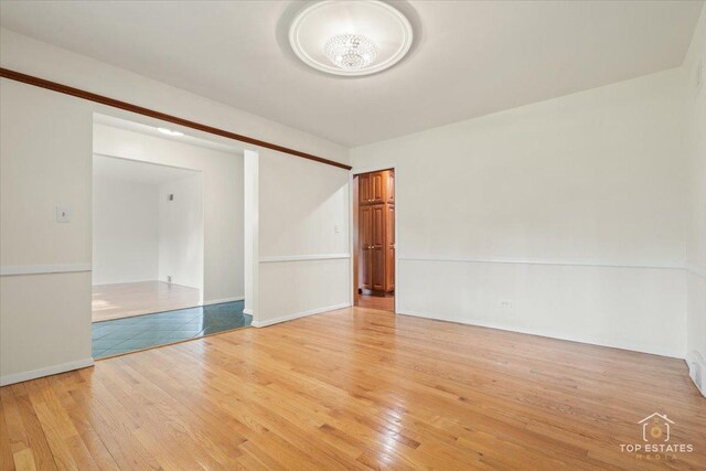 919 Santa Rosa Ave, Wheaton, IL 60187 - spare room with light wood-type flooring, a chandelier, and baseboards