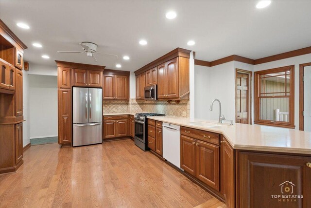 919 Santa Rosa Ave, Wheaton, IL 60187 - kitchen featuring appliances with stainless steel finishes, a sink, ceiling fan, a peninsula, and decorative backsplash