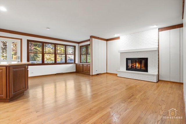 919 Santa Rosa Ave, Wheaton, IL 60187 - unfurnished living room featuring light wood-style flooring, a fireplace, healthy amount of natural light, and baseboards
