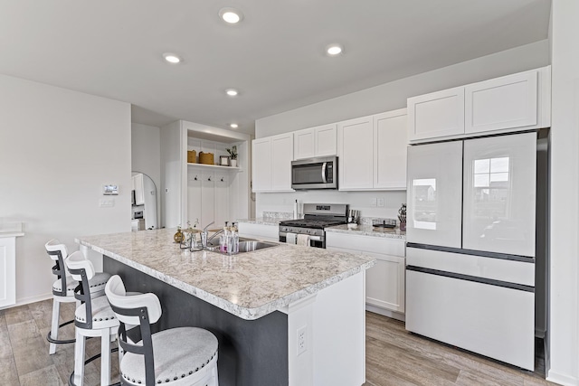 1187 Sonoma Ct, Pingree Grove, IL 60140 - kitchen with appliances with stainless steel finishes, a sink, white cabinetry, a breakfast bar, and recessed lighting