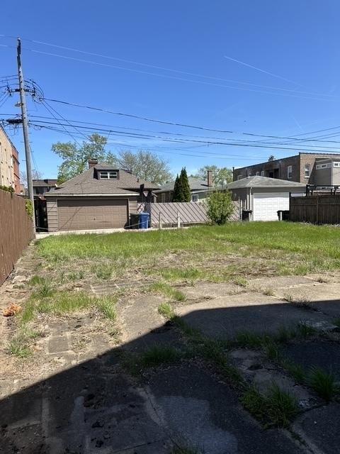 7347 S Paxton Ave, Chicago, IL 60649 - view of yard featuring fence and a garage