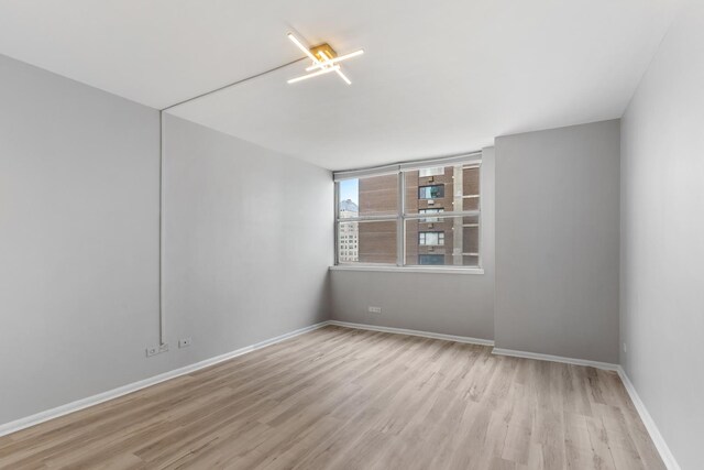 6301 N Sheridan Rd Unit 11D, Chicago, IL 60660 - unfurnished room with wood finished floors and baseboards