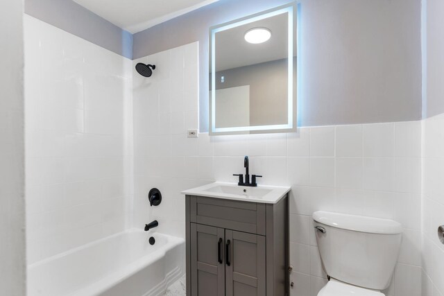6301 N Sheridan Rd Unit 11D, Chicago, IL 60660 - full bathroom featuring vanity, shower / bathtub combination, tile walls, and toilet