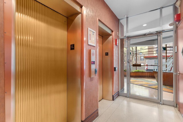 6301 N Sheridan Rd Unit 11D, Chicago, IL 60660 - hallway featuring elevator, dark speckled floor, and recessed lighting