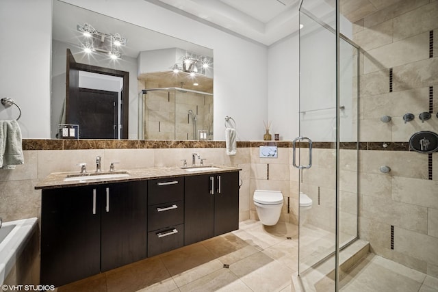 2130 W N Ave Unit 208, Chicago, IL 60647 - full bathroom featuring tile walls, a stall shower, double vanity, toilet, and tile patterned flooring