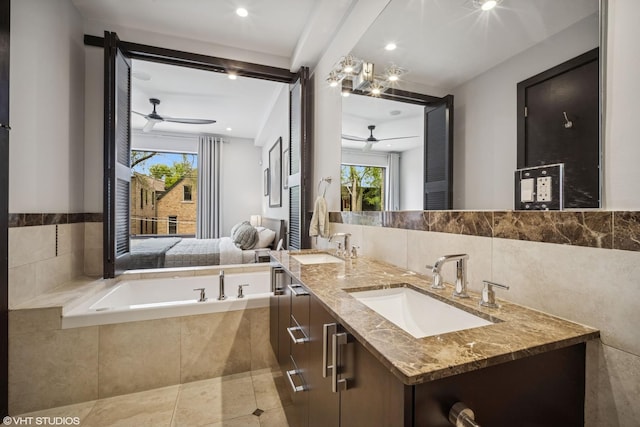 2130 W N Ave Unit 208, Chicago, IL 60647 - full bathroom featuring ceiling fan, plenty of natural light, a garden tub, double vanity, and tile walls