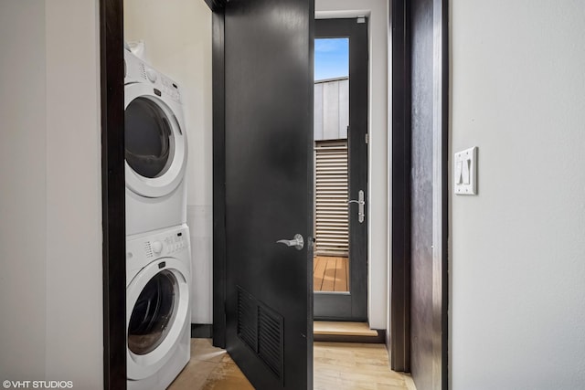 2130 W N Ave Unit 208, Chicago, IL 60647 - washroom with stacked washer / dryer and light wood-style floors