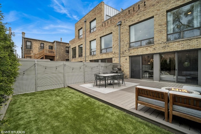 2130 W N Ave Unit 208, Chicago, IL 60647 - back of property featuring a fire pit, a wooden deck, brick siding, and outdoor dining area
