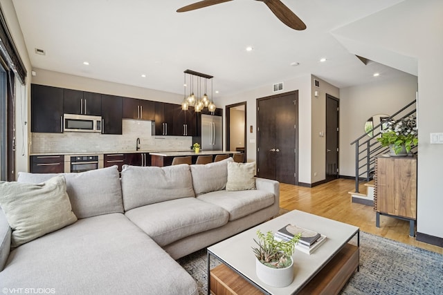 2130 W N Ave Unit 208, Chicago, IL 60647 - living area with stairway, light wood-type flooring, recessed lighting, ceiling fan, and baseboards