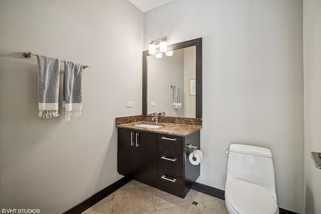 2130 W N Ave Unit 208, Chicago, IL 60647 - bathroom with baseboards, toilet, vanity, and tile patterned flooring