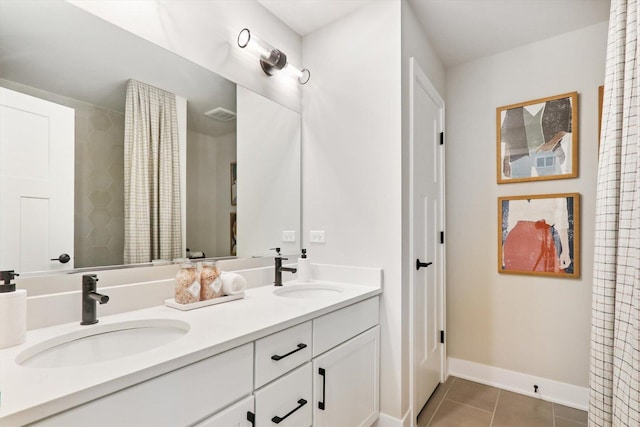 617 Henry Ln, Oswego, IL 60543 - bathroom featuring tile patterned floors, double vanity, and baseboards