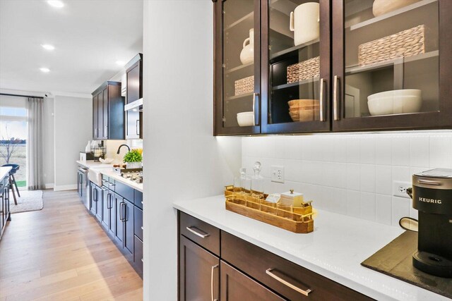 617 Henry Ln, Oswego, IL 60543 - bar with decorative backsplash, light wood-style floors, recessed lighting, a sink, and baseboards