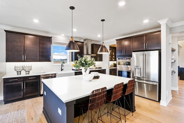 617 Henry Ln, Oswego, IL 60543 - kitchen with appliances with stainless steel finishes, a sink, a kitchen island, light wood-style flooring, and recessed lighting