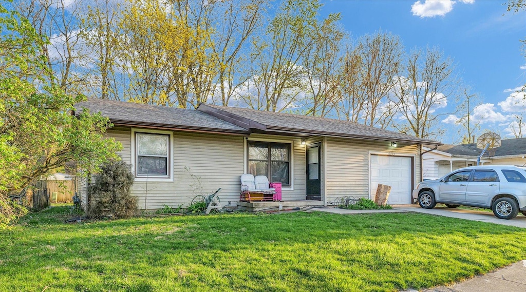 single story home featuring a garage, a front lawn, driveway, and roof with shingles