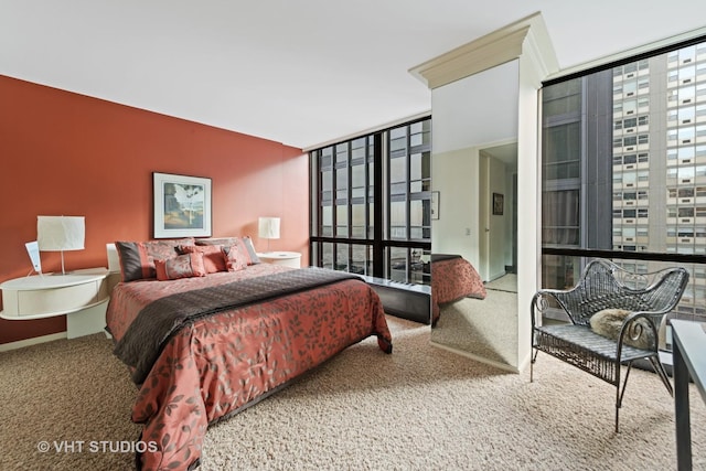 bedroom with carpet flooring, multiple windows, and floor to ceiling windows